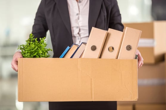 Man carrying a box in an office